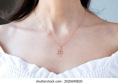 Close Up Young Woman In White Shirt Wearing Silver Necklace. Handmade Jewelry Design Concept Idea Photo