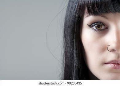 Close up of young woman's face with black hair - Powered by Shutterstock