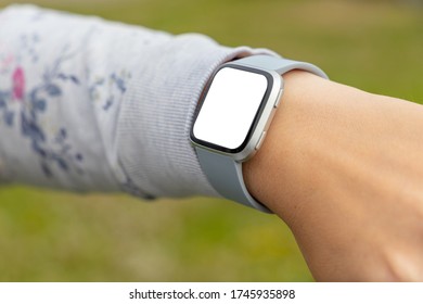 Close up young woman's hand using smart watch with blank screen.
