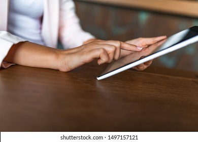 Close Up Of  Young Women Using Digital Tablet In The Office. Woman Working On A Tablet In A Home Office. Young Girl Works On The Tablet On The Internet,  Ipad Surfing, Woman Using Smartphone