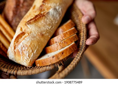 Close yp of man hand, holding basket with various bread freshly baked. Close up concept of homemade bread, small bakery, natural farm products, local food,  domestic production. Healthy tasty organic - Powered by Shutterstock