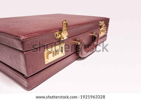 Closed 24 hour briefcase with open lock on white background