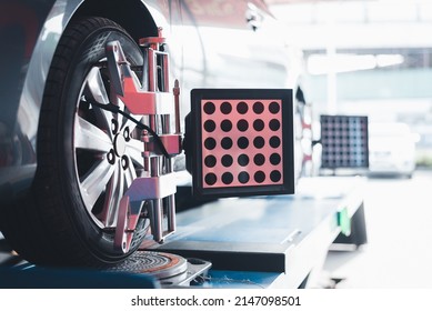 Closed Up Of An Auto Wheel : Wheel Alignment. Balancing Tire Wheel Machine. Tyre Assembling. Tire Balance - Car Service