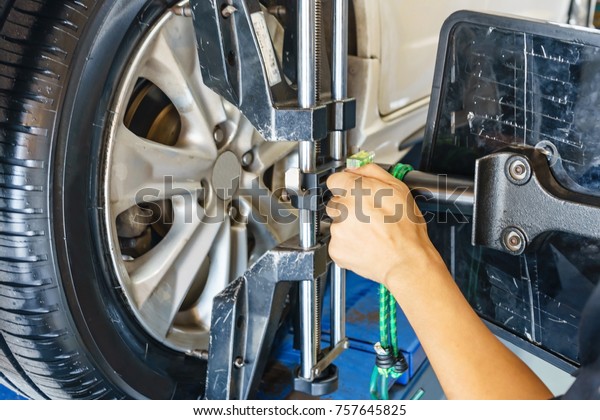 Closed up of an auto wheel : wheel alignment.\
Balancing tire wheel machine. Tyre assembling. Tire balance - Car\
service