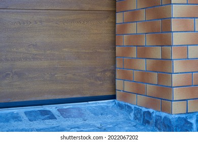 Closed Automatic Garage Doors,close Up Of A Brown Garage Door At The Bottom