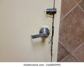 Closed Bathroom Door With Corrosion Or Damage On Door And Lock