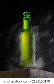 Closed Beer Green Bottle On A Wooden Desk. Freezing Ready To Drink. Cold Smoke