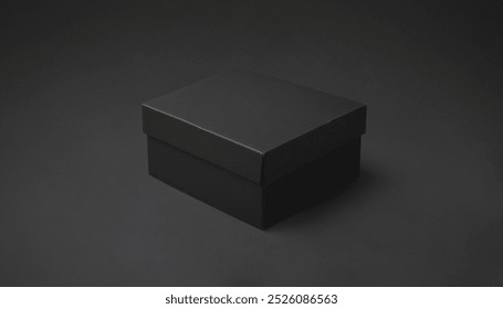 Closed black cardboard box is positioned on a plain black surface. Premium photo mockup for elegant and clean cardboard box product.