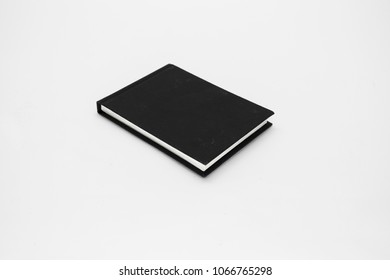 Closed Black Note Book Isolated On A White Table 