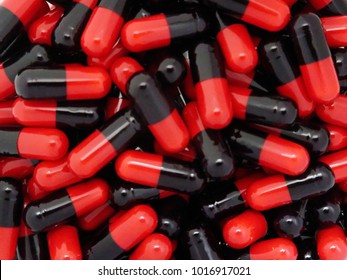 closed up Black Red capsules pills full in page for background. 