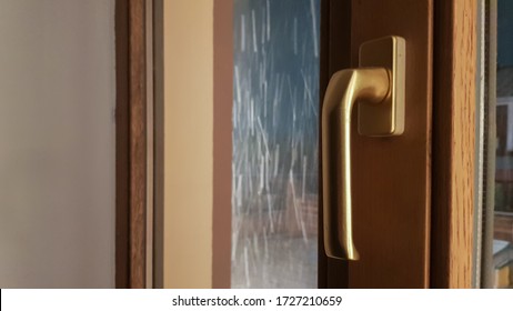 Closed Brown Plastic Window In The House. Close-up On A Pen. Lamination Of Window Glass Film, A Package Of Wood Light Brown