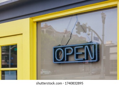 Closed Business With Neon Open Sign Hang On The Window