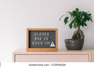 Closed business store due to COVID-19. Coronavirus lifestyle background with message sign at store front counter for closure of businesses and retail shops.