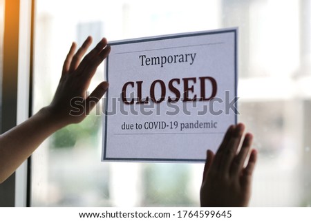 Closed businesses for COVID-19 pandemic outbreak, closure sign on retail store window banner background. Government shutdown of restaurants, shopping stores, non essential services.