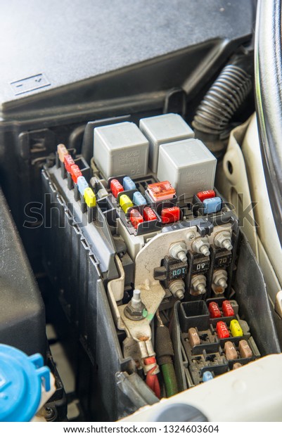 Closed up car\
fuse box, mini fuses and\
relays\
