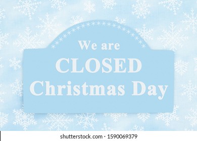 Closed Christmas Day Sign Message On A Wood Sign With A Blue Snowflakes