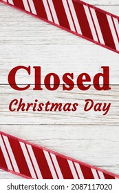 Closed Christmas Day Sign With Red And White Candy Cane Striped Border On Weathered Wood