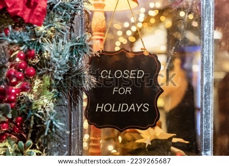 Closed for Christmas holidays, New Year vacations. text on signboard, board on window of cafe, shop, store in winter. High quality photo