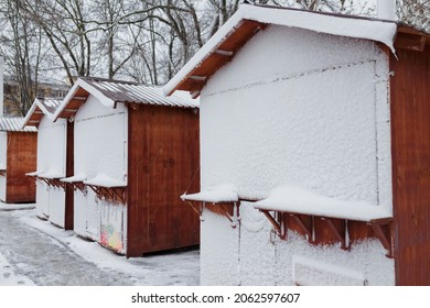 Closed Christmas Market At Winter Snowy Day. Wooden Stalls With Locks Covered With Snow.