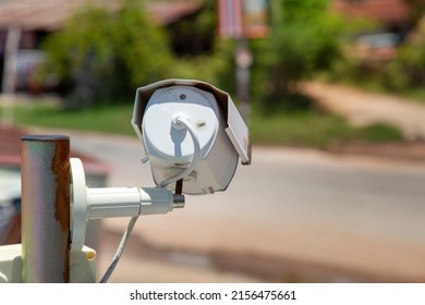 Closed circuit television camera recording in rural village on nature background.