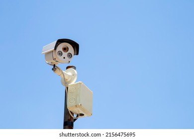 Closed Circuit Television Camera Recording On Blue Sky Background.