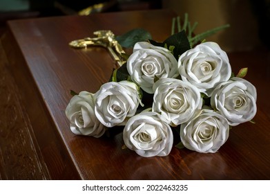 Closed coffin with white roses on the coffin lid, death of a person, burial, mortality of the population.