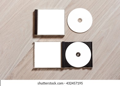 Closed Compact Disc Template With Plastic Box Case With White Isolated Blank For Branding Design And Open Box With Booklet. CD Jewel Case Mock Up With Clean Free Space For On Wooden Table. Top View