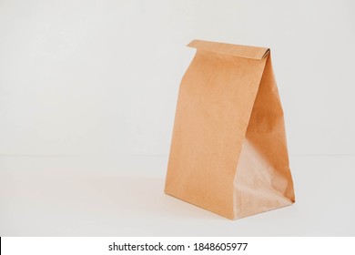 Closed disposable package made of brown kraft paper on a white background. Copy, empty space for text - Shutterstock ID 1848605977