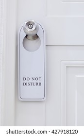 Closed Door Of Hotel Room With Please Do Not Disturb Sign