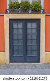 Closed Double Doors With Potted Plants Decor At Terracotta Building