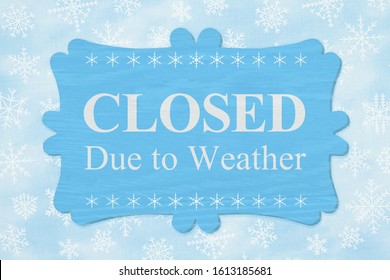Closed Due to Weather message on a wood sign with a blue snowflakes - Shutterstock ID 1613185681