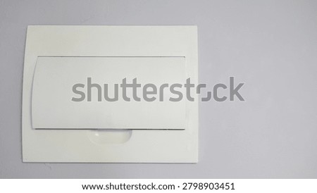 Closed electrical circuit breaker panel in an apartment interior. Close-up of a home electrical distribution box used for safe power control and household energy management