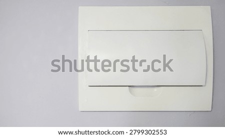 Closed electrical circuit breaker panel in an apartment interior. Close-up of a home electrical distribution box used for safe power control and household energy management