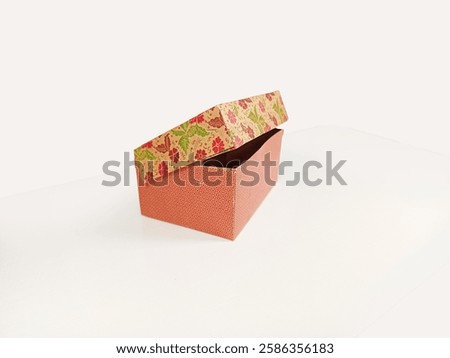 A closed empty snack box made from paperboard on a white background.