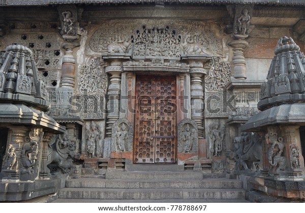 Closed entrance to the ancient Indian temple. The\
massive wooden door is\
locked.