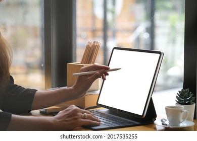 Closed Up With Female Hand Use Stylus Pen Writing With Digital Tablet, Empty Screen Of Tablet And Sitting On The Coffee Bar.