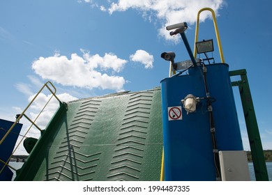 Closed Ferry Gate Or Drawbridge In Front Of Blue Summer Sky. Close Up.