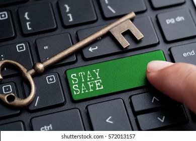 Closed up finger on keyboard with word STAY SAFE
