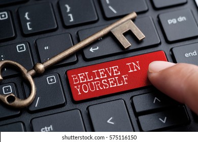 Closed up finger on keyboard with word BELIEVE IN YOURSELF