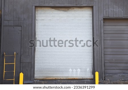 closed garage door symbolizes security, privacy, and hidden potential. The mundane facade conceals untold stories and aspirations