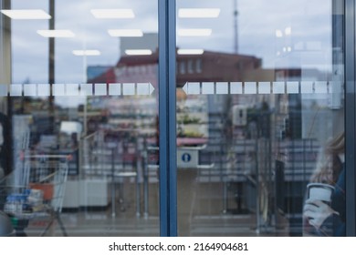 Closed glass supermarket automatic door, front view.