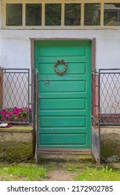 Closed Green Door At Old House With Transom Window