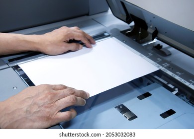 Closed Up Hand Holding White Paper On Printer, Printer Scanner Laser Office Copy Machine Supplies Start Concept. Selective Focus On Right Hand.