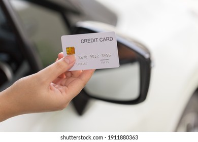 Closed Up Hand Use Credit Card On Car To Pay For Fuel