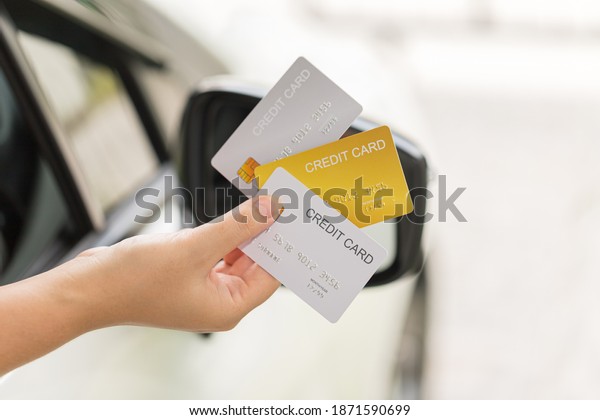 closed up hand use credit card on car to pay or to\
access the gate