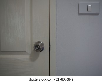 Closed Hotel Door With Lock And Light Switch In Room 