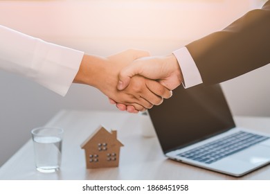 Closed Up Of House Agent Handshake  To Congratulate Customer On Becoming A New Landlord.