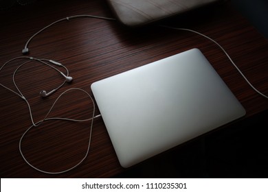 Closed Laptop On A Messy Desk.
Time To Relax, Take A Nap And Go Offline.