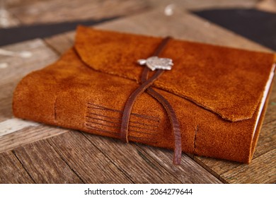 Closed leather journal on wood