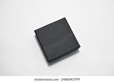 Closed lid used black watch box, plain black jewelry or watch box in a closed position with a slight shadow on a white background, suitable for brand mockup